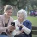 Canva - Cheerful senior mother and adult daughter using smartphone together